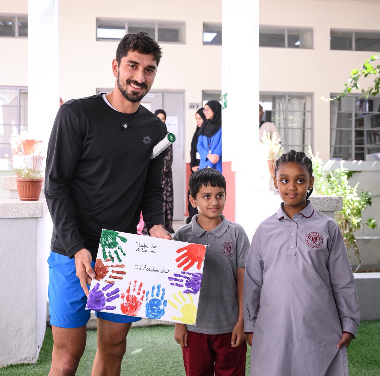 Hady Habib receives a thank you gift from the students.